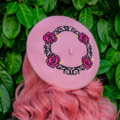 Person with pink hair holding a white flower against a green leafy background